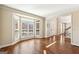Inviting living room featuring hardwood floors, bay windows, and staircase nearby at 4569 Chatsworth Ovrlk Ne, Roswell, GA 30075