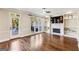 Well-lit living room featuring a fireplace, built-in shelves, and hardwood floors at 4569 Chatsworth Ovrlk Ne, Roswell, GA 30075