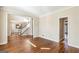 Spacious living room featuring hardwood floors and an adjacent staircase at 4569 Chatsworth Ovrlk Ne, Roswell, GA 30075