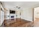 Cozy living room with fireplace, built-in shelves, hardwood floors, and neutral decor at 4569 Chatsworth Ovrlk Ne, Roswell, GA 30075