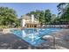 Inviting community pool with lounge chairs and umbrellas surrounded by mature trees and lush landscaping at 4569 Chatsworth Ovrlk Ne, Roswell, GA 30075