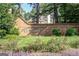 Community entrance featuring a brick sign and landscaped surroundings at 4569 Chatsworth Ovrlk Ne, Roswell, GA 30075