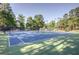 Outdoor tennis courts surrounded by lush trees and landscaping at 4569 Chatsworth Ovrlk Ne, Roswell, GA 30075