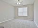 Bedroom with a neutral carpet, single window, and ceiling fan at 12241 Crestwood Ct, Fayetteville, GA 30215