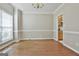 Open dining room showcasing beautiful hardwood floors, a chandelier, and a large window at 12241 Crestwood Ct, Fayetteville, GA 30215