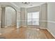 Open dining room featuring hardwood floors, a large window, and detailed trim work at 12241 Crestwood Ct, Fayetteville, GA 30215