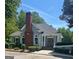 Charming gray home featuring a brick chimney, double front doors and manicured landscaping at 12241 Crestwood Ct, Fayetteville, GA 30215
