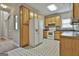 Bright kitchen showcasing wooden cabinets, white appliances, and tile flooring at 12241 Crestwood Ct, Fayetteville, GA 30215