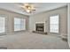 Spacious living room with a cozy fireplace and large windows at 12241 Crestwood Ct, Fayetteville, GA 30215