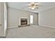 Cozy living room features stone fireplace and neutral carpet at 12241 Crestwood Ct, Fayetteville, GA 30215