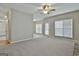 Open-concept living room with natural light and smooth carpet at 12241 Crestwood Ct, Fayetteville, GA 30215