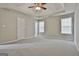 Large main bedroom boasts a ceiling fan and ample natural light at 12241 Crestwood Ct, Fayetteville, GA 30215