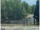Exterior view of community tennis court on a sunny day with mature trees at 12241 Crestwood Ct, Fayetteville, GA 30215