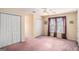 Spacious bedroom with double closets, large window, and neutral carpet at 149 Crown Oaks Dr, Stockbridge, GA 30281