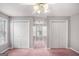 Spacious bedroom with large closets and a window; light gray walls and pink carpet at 149 Crown Oaks Dr, Stockbridge, GA 30281