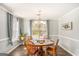 Well-lit dining room features a classic chandelier and space for four guests at 149 Crown Oaks Dr, Stockbridge, GA 30281