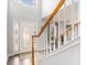 Bright foyer with staircase featuring a decorative glass front door and hardwood floors at 149 Crown Oaks Dr, Stockbridge, GA 30281