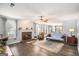 Inviting living room features a brick fireplace, ceiling fan, and hardwood floors at 149 Crown Oaks Dr, Stockbridge, GA 30281