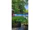 Backyard pool surrounded by lush greenery and a black fence, perfect for relaxation at 149 Crown Oaks Dr, Stockbridge, GA 30281