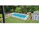 Backyard pool featuring a diving board, surrounded by concrete and a black metal fence at 149 Crown Oaks Dr, Stockbridge, GA 30281