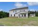 Spacious backyard showing lush grass, a covered patio, and the rear of the home at 127 Felicity Pike, Locust Grove, GA 30248