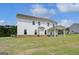 Backyard view of a white two-story home, covered patio, and manicured lawn at 127 Felicity Pike, Locust Grove, GA 30248