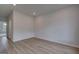 Empty room featuring vinyl flooring, white walls, natural light from a nearby window and electrical outlets at 127 Felicity Pike, Locust Grove, GA 30248