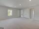 Expansive bonus room with neutral carpet offers flexibility for various uses at 127 Felicity Pike, Locust Grove, GA 30248