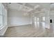 Spacious room boasts elegant chandelier, large windows, and seamless access to the rest of the house at 127 Felicity Pike, Locust Grove, GA 30248