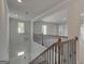 A light-filled foyer features iron-detailed stairs and an open floor plan at 127 Felicity Pike, Locust Grove, GA 30248