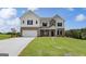 Charming two-story home featuring brick accents, a spacious two-car garage, and meticulously manicured lawn at 127 Felicity Pike, Locust Grove, GA 30248