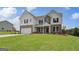 Beautiful two-story home with mixed brick and shingle facade, offering a well-manicured lawn at 127 Felicity Pike, Locust Grove, GA 30248