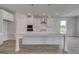 Bright kitchen with a large island, stainless steel appliances, and white cabinets at 127 Felicity Pike, Locust Grove, GA 30248