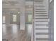 Open-concept living space features hardwood floors, coffered ceilings, and ample natural light at 127 Felicity Pike, Locust Grove, GA 30248