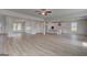 Open-concept living room and kitchen area with white cabinets at 127 Felicity Pike, Locust Grove, GA 30248