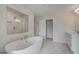 Elegant bathroom with a soaking tub, glass shower, and dual sink vanity at 127 Felicity Pike, Locust Grove, GA 30248