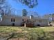 Exterior of the house features a back deck, a brick chimney and green backyard at 554 Fieldstream Way, Lawrenceville, GA 30044