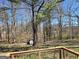 Scenic backyard view from the deck, showcasing mature trees and a storage shed at 554 Fieldstream Way, Lawrenceville, GA 30044