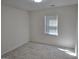 Light-filled bedroom with neutral carpet and a large window at 554 Fieldstream Way, Lawrenceville, GA 30044