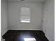 Empty bedroom with wood floor, a large window, and neutral walls at 554 Fieldstream Way, Lawrenceville, GA 30044