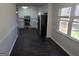 Spacious kitchen with stainless steel appliances, white cabinets, and a view to a wood deck at 554 Fieldstream Way, Lawrenceville, GA 30044