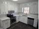 Bright kitchen featuring white cabinets, marble countertops, and stainless steel appliances at 554 Fieldstream Way, Lawrenceville, GA 30044