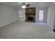 Cozy living room with a stone fireplace and neutral carpet at 554 Fieldstream Way, Lawrenceville, GA 30044