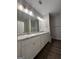 Bathroom featuring double vanity, granite countertops, and wood-look vinyl flooring at 11144 Cornerstone Way, Hampton, GA 30228