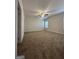 Spacious bedroom featuring neutral carpet, a ceiling fan, and large windows for natural light at 11144 Cornerstone Way, Hampton, GA 30228