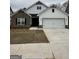 Modern two-story home featuring a mix of stone and siding, a two-car garage, and a well-manicured lawn at 11144 Cornerstone Way, Hampton, GA 30228
