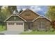 Charming craftsman-style home with stone accents, inviting curb appeal, and a two-car garage at 11144 Cornerstone Way, Hampton, GA 30228