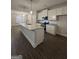 Modern kitchen with granite countertops, white cabinets, stainless steel appliances, and center island at 11144 Cornerstone Way, Hampton, GA 30228