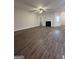 Spacious living room with wood-look floors, a cozy fireplace, and ample natural light at 11144 Cornerstone Way, Hampton, GA 30228