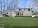 Expansive backyard with lush green grass and an exterior view of the sunroom, perfect for outdoor enjoyment at 114 Mcbride Rd, Fayetteville, GA 30215